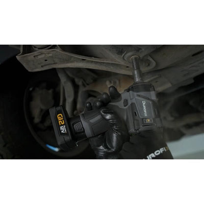 Person using a power drill on a vehicle's undercarriage