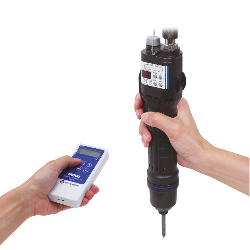 Hand holding a dental drill and control unit on a white background